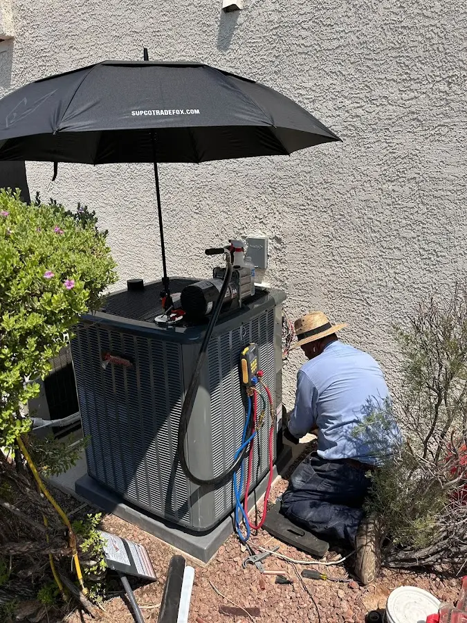 HVAC technician performing outdoor AC maintenance in Flossmoor
